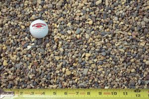 buckshot aggregate shown with a measuring tape and golf ball for size comparison