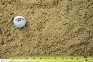 fill sand - screened shown with a measuring tape and golf ball for size comparison