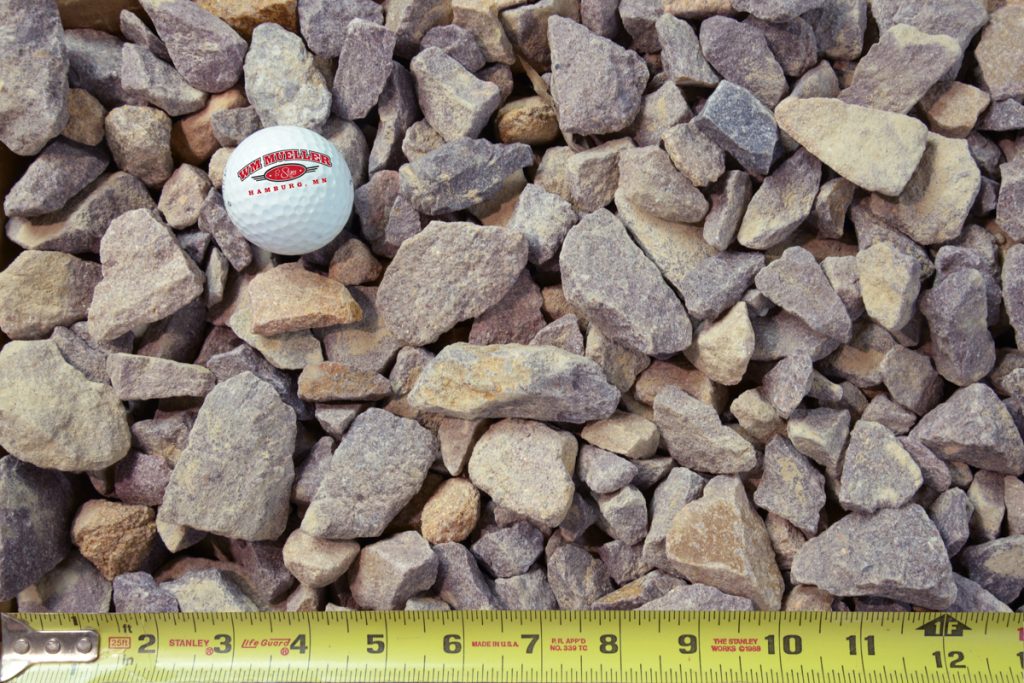 quartz rock shown with a measuring tape and golf ball for size comparison