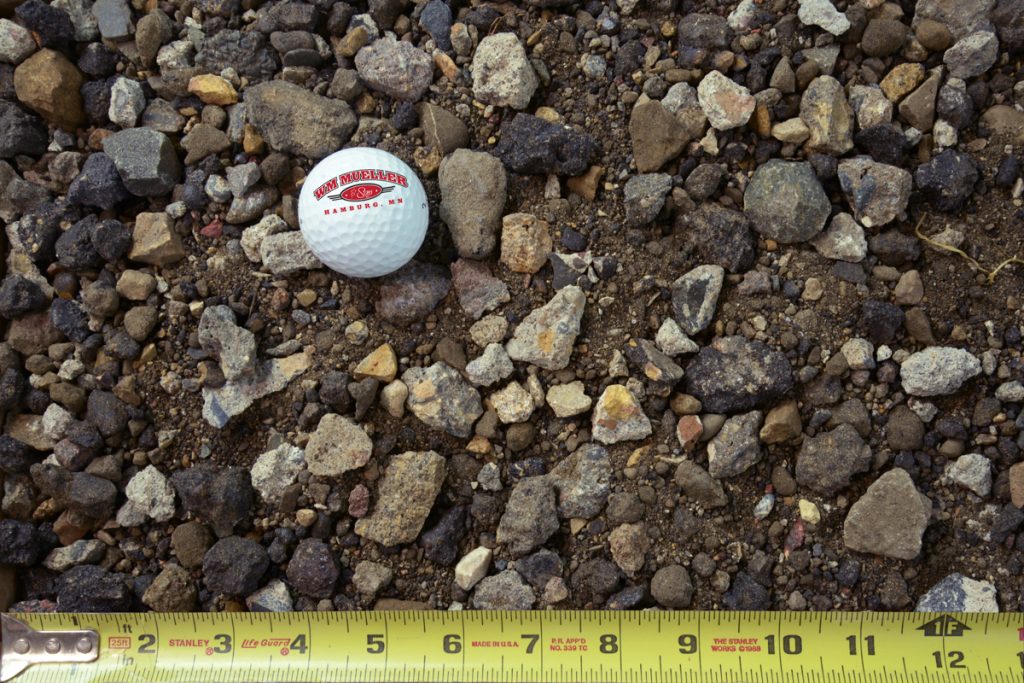 Recycled mix shown with a measuring tape and golf ball for size comparison