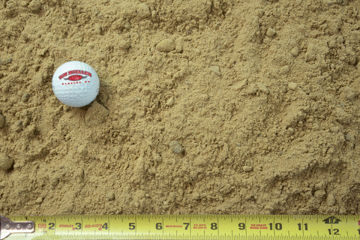 fill sand - screened shown with a measuring tape and golf ball for size comparison