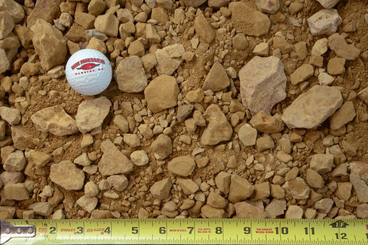 1.5" minus limestone with golf ball and measuring tape for size comparison