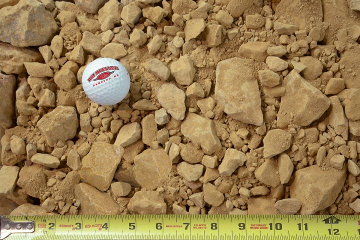 3in minus limestone with measuring tape and golf ball for size comparison