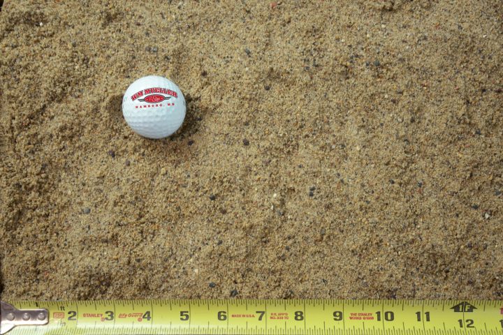 plaster sand shown with a measuring tape and golf ball for size comparison